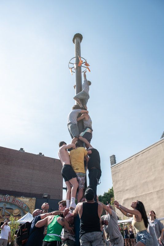 Italian Market Festival Grease Pole Climbing Competition