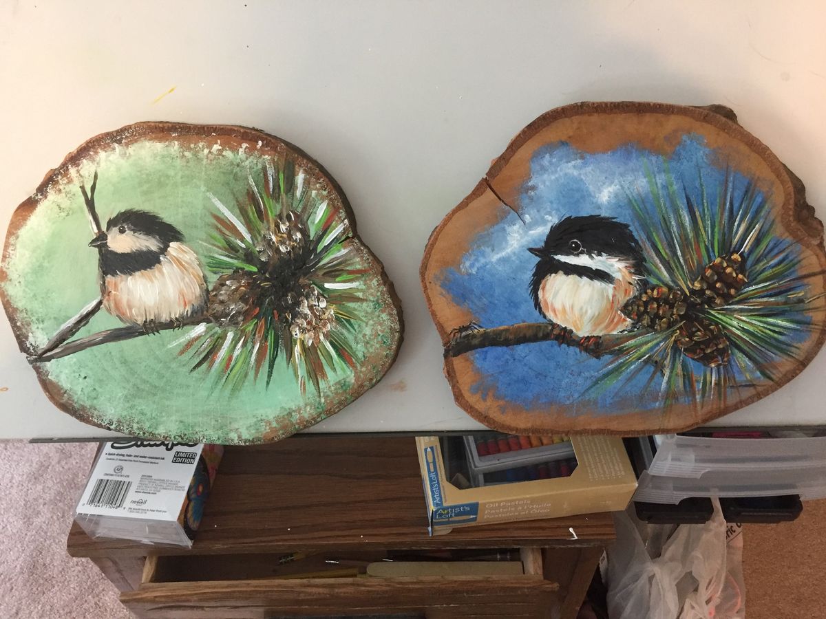 Chickadees on wood rounds