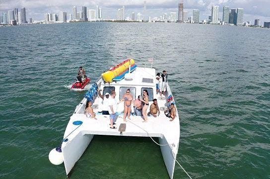 Catamaran watersports party Ultimate Excursion Jet skis, tubing, tour drink