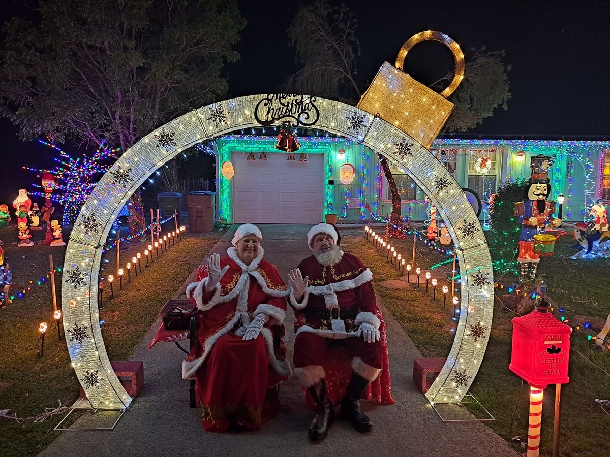 Santa and Mrs. Claus with light display