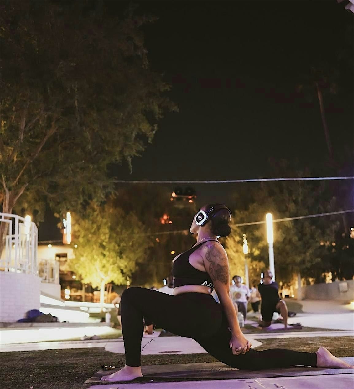 Silent headphone yoga at sunset