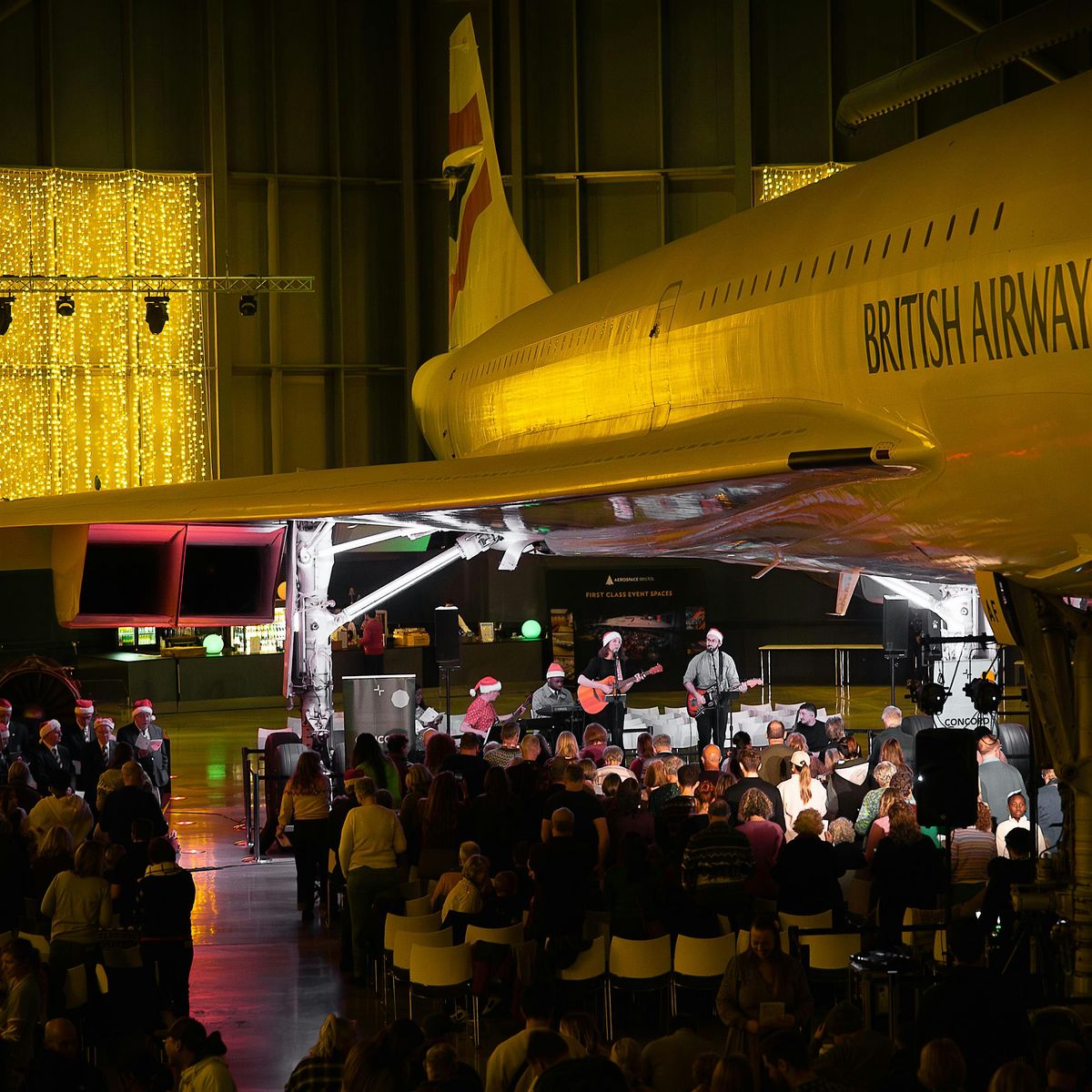 Community carol service under Concorde
