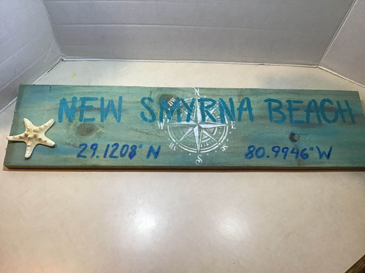 New Smyrna Beach (or other city) sign with coordinates and starfish